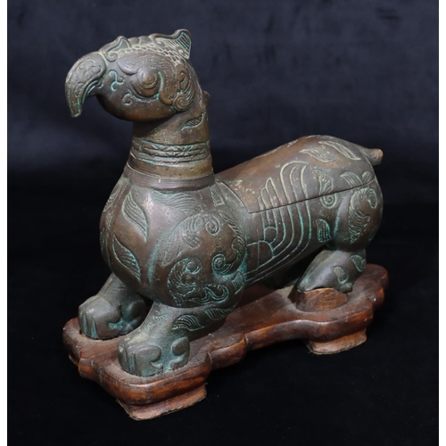 808 - A bronzed table light/cigarette box in the form of a mythological animal, allover leaf and scroll de... 