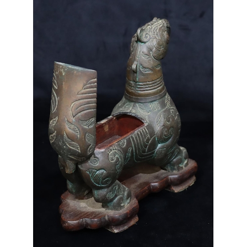 808 - A bronzed table light/cigarette box in the form of a mythological animal, allover leaf and scroll de... 