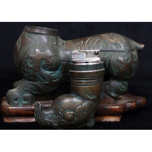 808 - A bronzed table light/cigarette box in the form of a mythological animal, allover leaf and scroll de... 