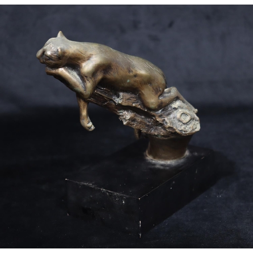 810 - A composition bronzed figure of a leopard lying on a branch, indistinctly monogrammed on black recta... 