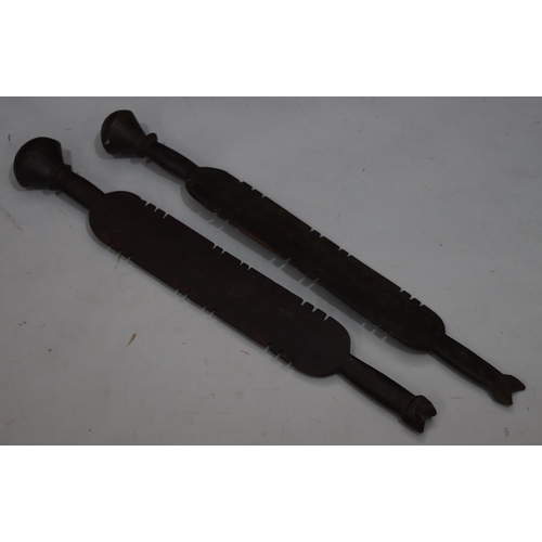 818 - A pair of early carved African wooden clubs with parquetry decoration, 84cm long