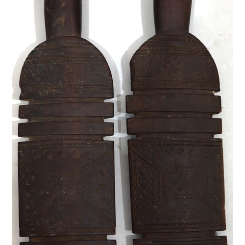 818 - A pair of early carved African wooden clubs with parquetry decoration, 84cm long