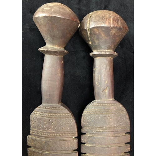 818 - A pair of early carved African wooden clubs with parquetry decoration, 84cm long