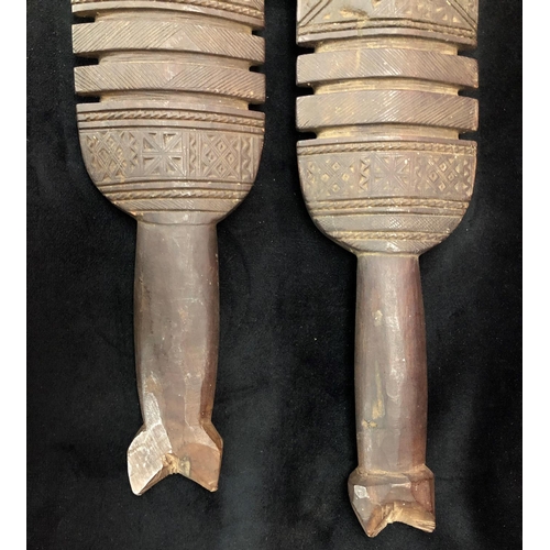 818 - A pair of early carved African wooden clubs with parquetry decoration, 84cm long