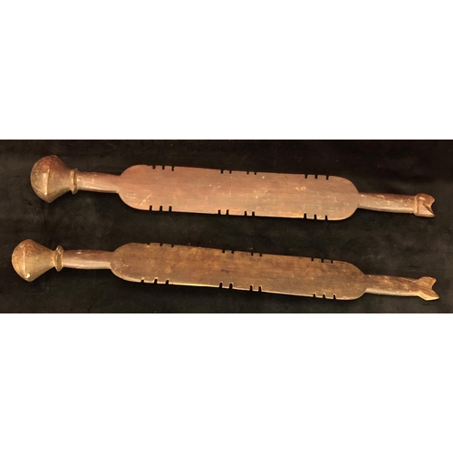 818 - A pair of early carved African wooden clubs with parquetry decoration, 84cm long