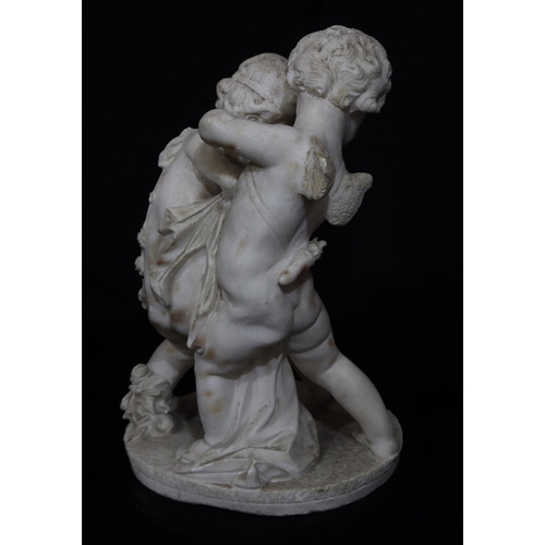 820 - A white marble group of 2 cupids on round base (wings to 1 a/f), 43cm high