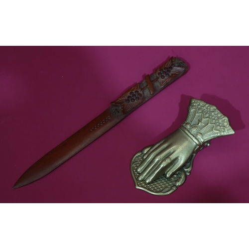 822 - A carved wooden paper knife with raised grape and vine decoration, 25cm long, a brass table clip in ... 