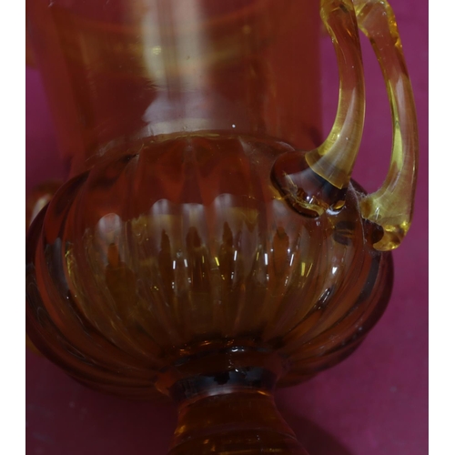 83 - A 16th Century amber glass round bulbous 2-handled trumpet shaped Pania vase on sweeping base, 25cm ... 