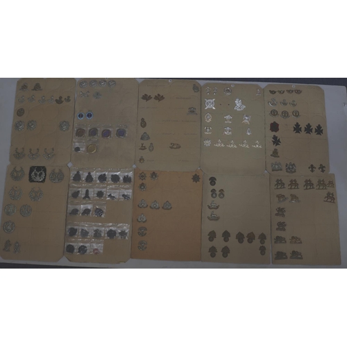 845 - A quantity of various military and other cap badges etc mounted on 10 boards