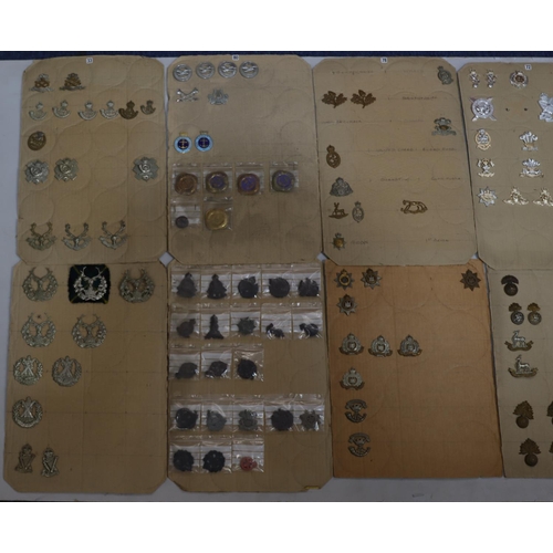 845 - A quantity of various military and other cap badges etc mounted on 10 boards