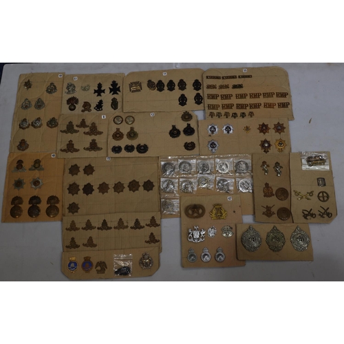 848 - A quantity of various military and other cap badges etc mounted on 16 cut boards