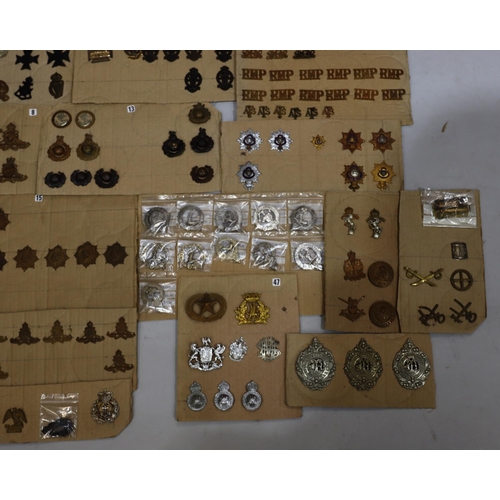 848 - A quantity of various military and other cap badges etc mounted on 16 cut boards