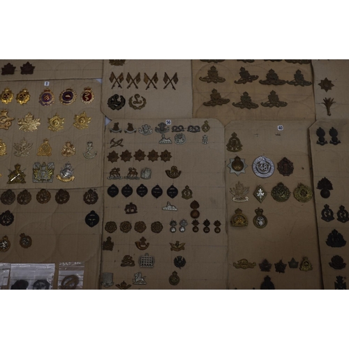 849 - A quantity of various military and other cap badges etc mounted on 14 boards