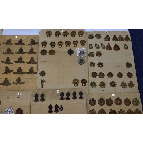 849 - A quantity of various military and other cap badges etc mounted on 14 boards