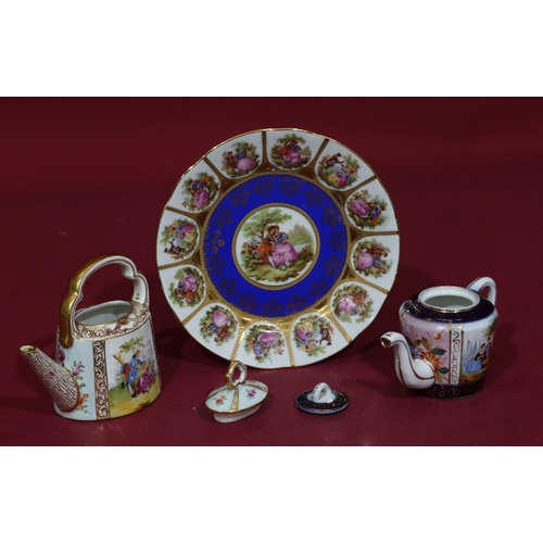 85 - A Dresden small oval teapot with multicoloured figure, floral and gilt decoration, fixed overhead ha... 