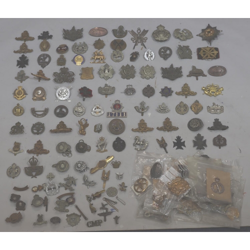 853 - A large quantity of various military and other badges including belts etc.