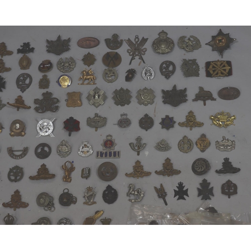 853 - A large quantity of various military and other badges including belts etc.