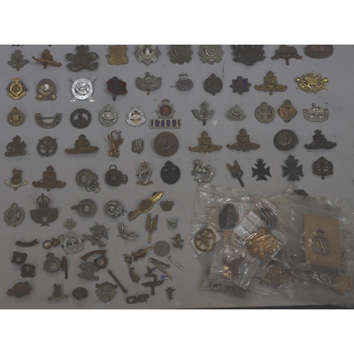 853 - A large quantity of various military and other badges including belts etc.