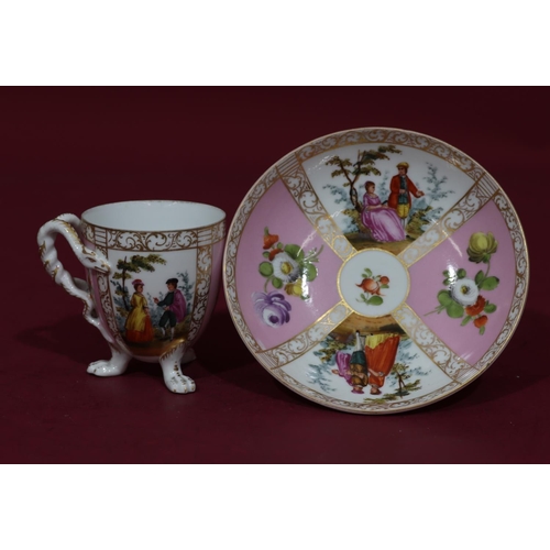 90 - A Dresden cup and saucer on white and pink ground with multicoloured figure, floral, leaf and gilt d... 
