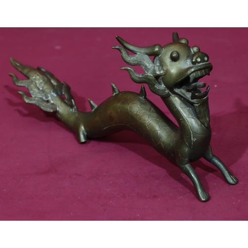 904 - An Oriental gilt bronze figure of a dragon, 34.5cm long, 15.5cm high