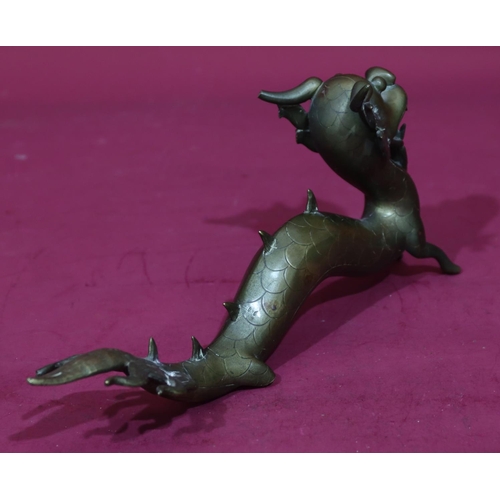 904 - An Oriental gilt bronze figure of a dragon, 34.5cm long, 15.5cm high