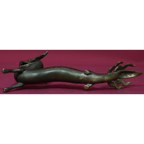 904 - An Oriental gilt bronze figure of a dragon, 34.5cm long, 15.5cm high