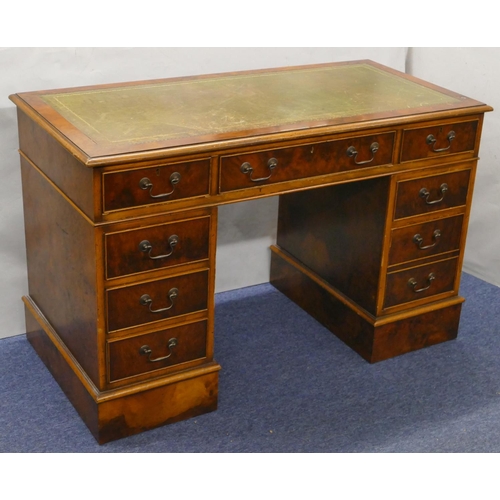 926 - A good quality reproduction walnut small kneehole double pedestal desk with green leather inset top,... 