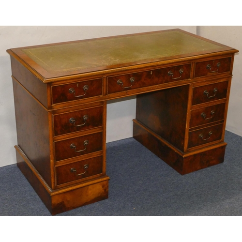 926 - A good quality reproduction walnut small kneehole double pedestal desk with green leather inset top,... 