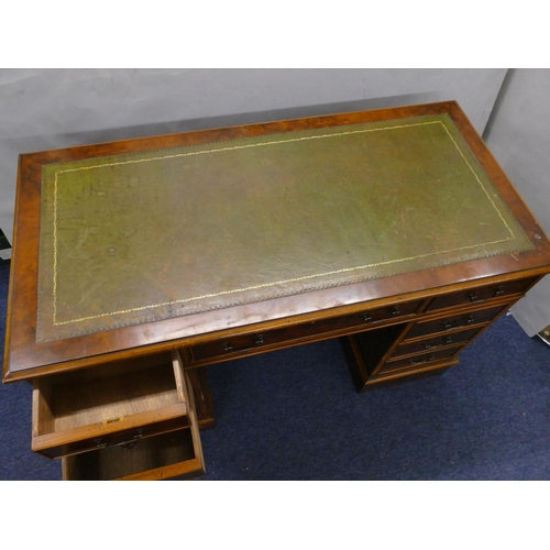 926 - A good quality reproduction walnut small kneehole double pedestal desk with green leather inset top,... 