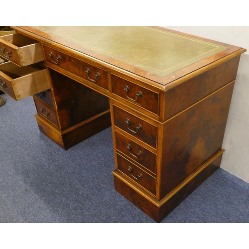 926 - A good quality reproduction walnut small kneehole double pedestal desk with green leather inset top,... 