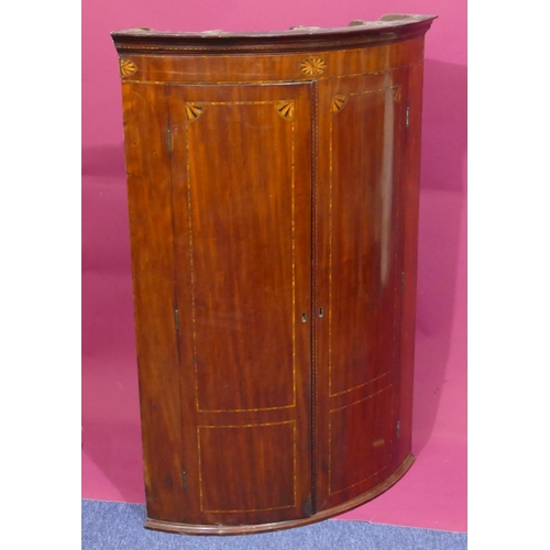 927 - A George III mahogany small bow fronted hanging corner cupboard with inlaid star motifs, 2 panel doo... 