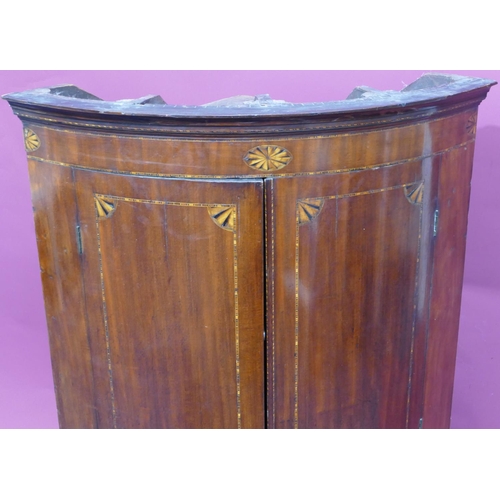 927 - A George III mahogany small bow fronted hanging corner cupboard with inlaid star motifs, 2 panel doo... 