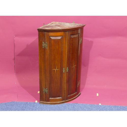 928 - A George III mahogany bow fronted hanging corner cupboard with allover marquetry, shell and banding ... 