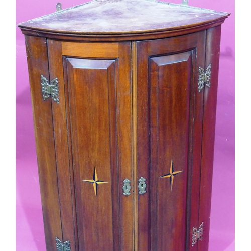 928 - A George III mahogany bow fronted hanging corner cupboard with allover marquetry, shell and banding ... 