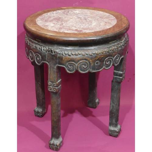 930 - A Chinese round hardwood stand with marble inset top and raised carved scroll decoration on 4 legs w... 