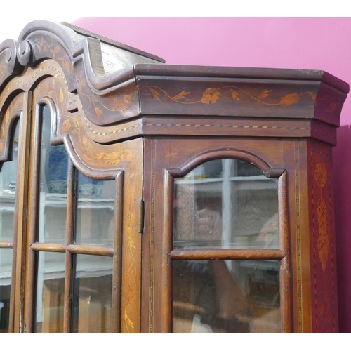 932 - A 19th Century Continental marquetry bookcase with scallop shaped scroll top, allover bird, basket, ... 