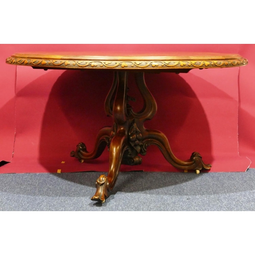 936 - A Victorian bur walnut round tilt-top breakfast table with carved floral and scroll rim, tri-pod bas... 