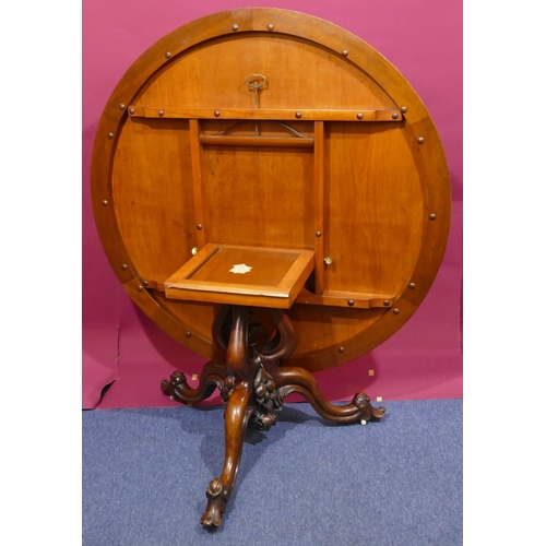 936 - A Victorian bur walnut round tilt-top breakfast table with carved floral and scroll rim, tri-pod bas... 