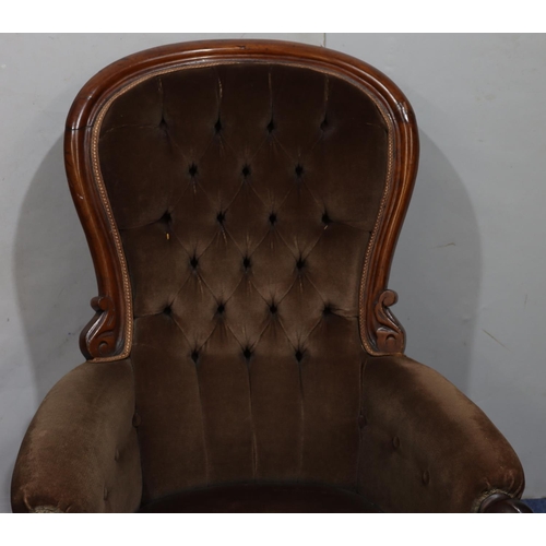 941 - A 19th Century mahogany spoon back armchair with brown velvet overstuffed seat, button back and padd... 