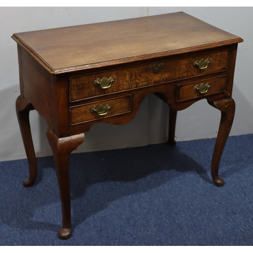 947 - An oak lowboy with long drawer above kneehole and 2 short drawers with drop brass handles on cabriol... 