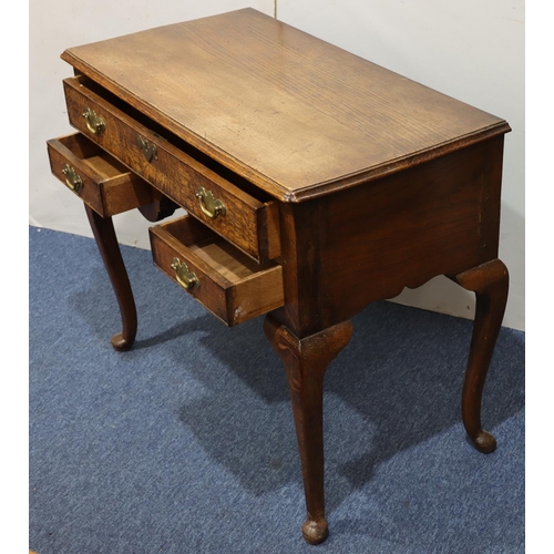 947 - An oak lowboy with long drawer above kneehole and 2 short drawers with drop brass handles on cabriol... 