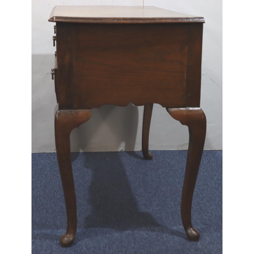 947 - An oak lowboy with long drawer above kneehole and 2 short drawers with drop brass handles on cabriol... 