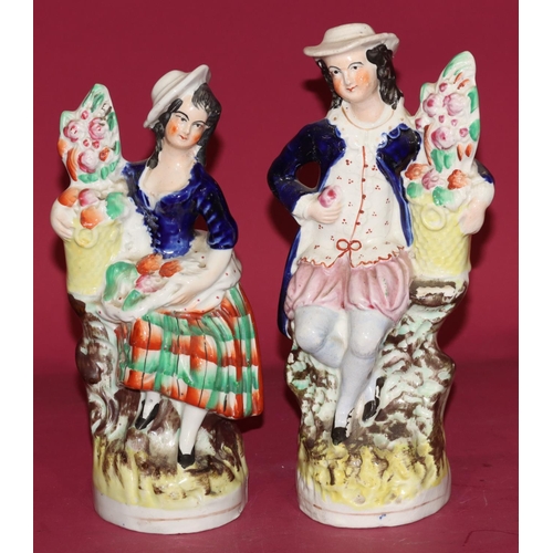 99 - A pair of 19th Century Staffordshire figures of gardeners, both 23cm high (2)