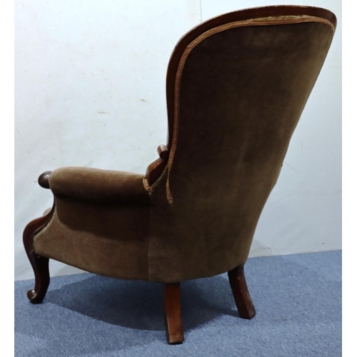 941 - A 19th Century mahogany spoon back armchair with brown velvet overstuffed seat, button back and padd... 