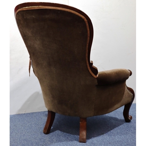 941 - A 19th Century mahogany spoon back armchair with brown velvet overstuffed seat, button back and padd... 