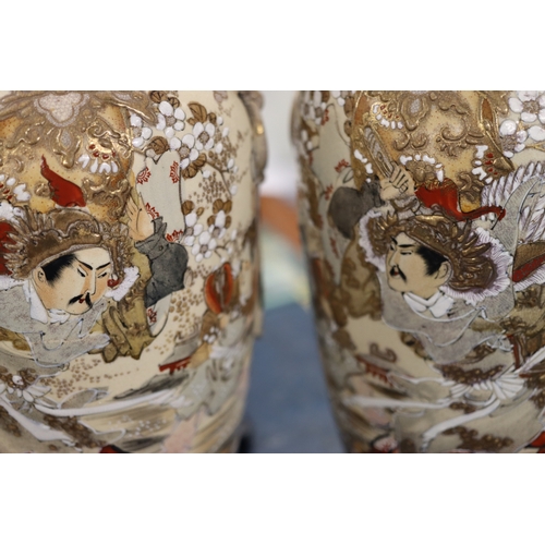 1008 - A pair of 20th Century Satsuma vases on cream ground with multi-coloured figure, floral and gilt dec... 