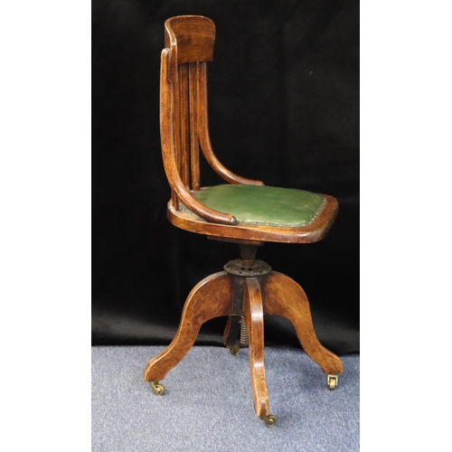 1021 - A desk chair with green leather adjustable seat, brass castors, 43.5cm high, 41cm deep overall. This... 