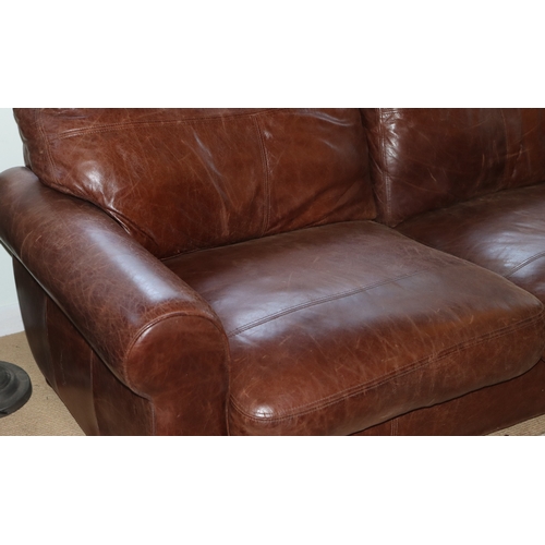 1039 - A brown 3- seater leather sofa, 2 base cushions, 2 back cushions with velcro fittings, on wood bun f... 