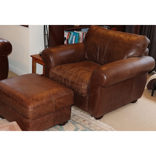 1041 - A brown  leather armchair, 1 base cushion, 1 back cushion with velcro fittings, on wood bun feet, 10... 