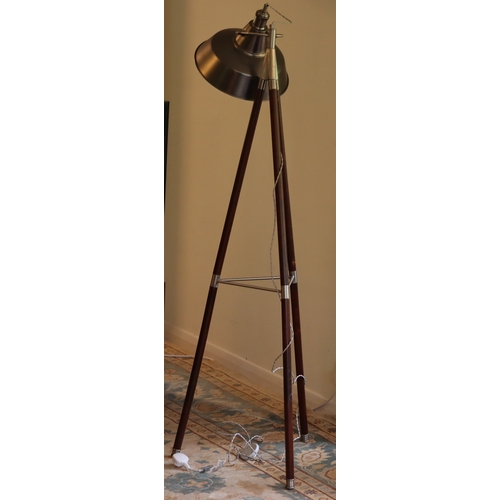 1044 - A modern floor lamp on wood and metal tripod legs with metallic adjustable shade, 149cm high overall... 